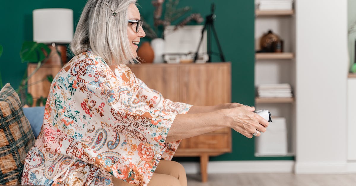 Playing Mass Effect on multiple consoles - An Elderly Woman Holding a Game Controller