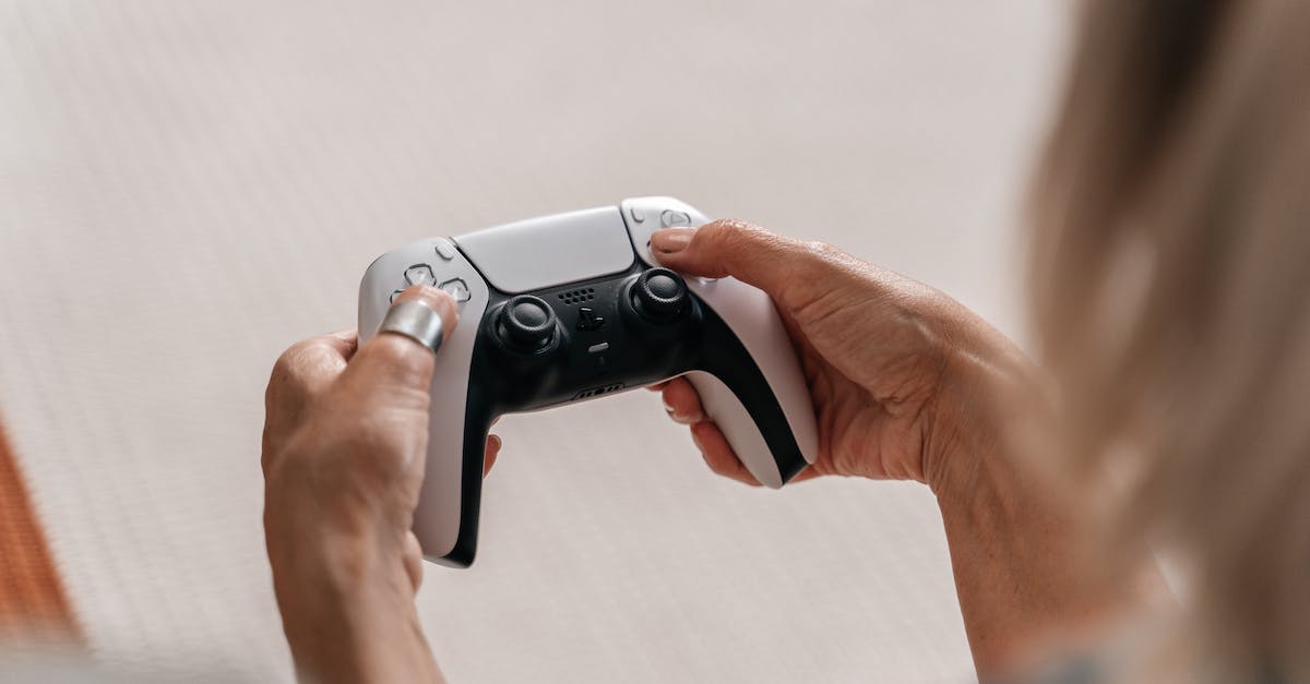 Playing Mass Effect on multiple consoles - A Person Holding a Game Controller