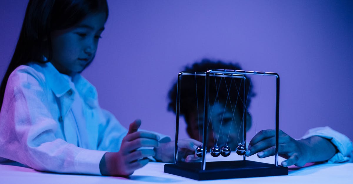 Playing Minecraft Demo Mode Immediately by Moving Files - Boy and girl playing with newton s cradle in a blue light
