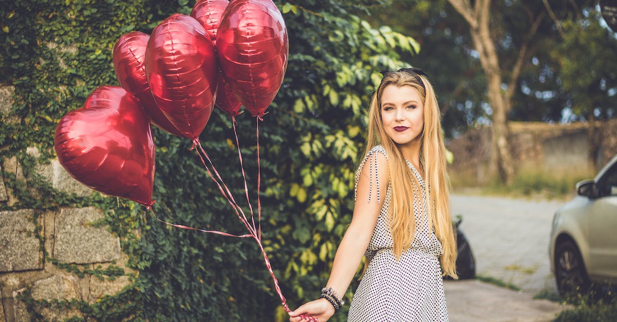 Playing Red Alert on LAN - Woman Wearing Grey Dress Holding Heart Balloons
