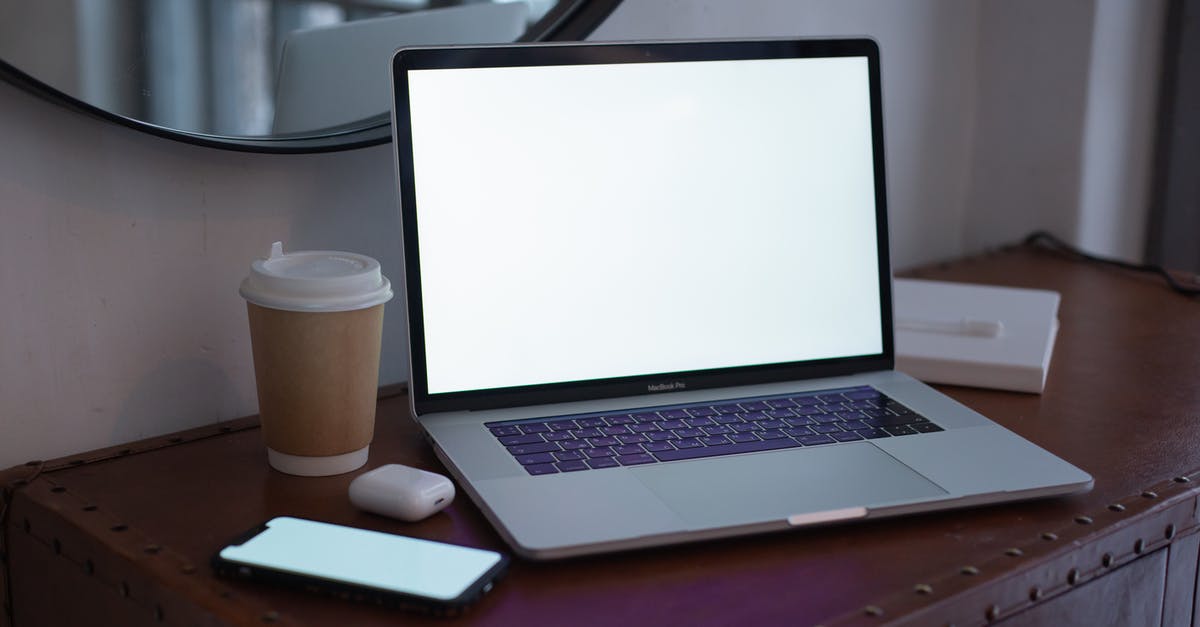 Playstation 3 on PC Monitor - Macbook Pro on Brown Wooden Table