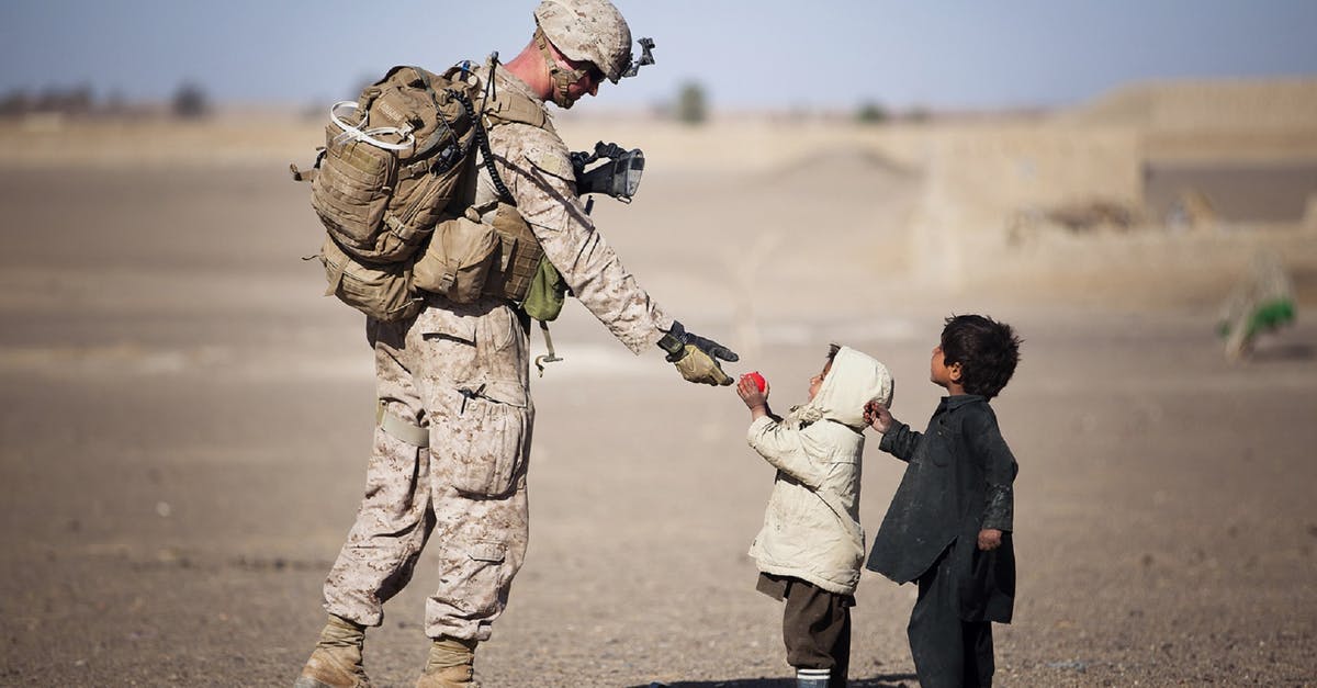 Playstation 3 Sharing Accounts - Soldier Giving Red Fruit on 2 Children during Daytime