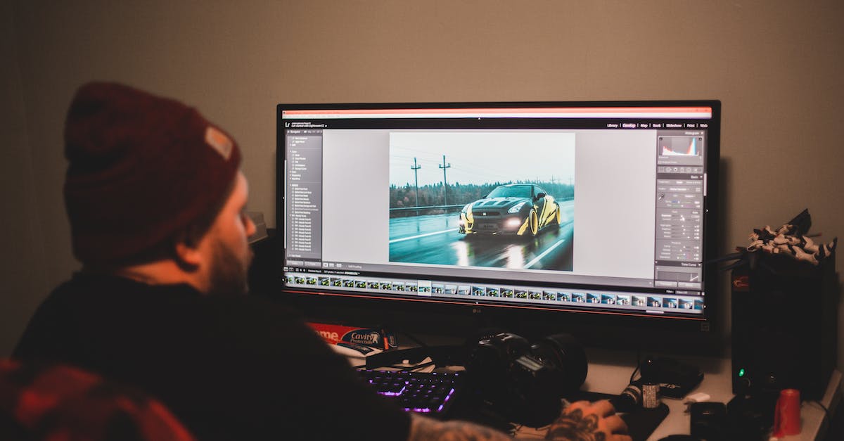 PlayStation 4 video drops when connected to Dell monitor via HDMI-to-DisplayPort adapter - Unrecognizable tattooed male sitting at table and working on computer with montage video of sport car