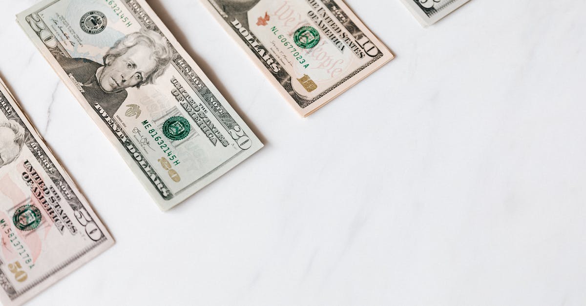 Playstation plus account on different consoles - Set of various dollar banknotes on white table