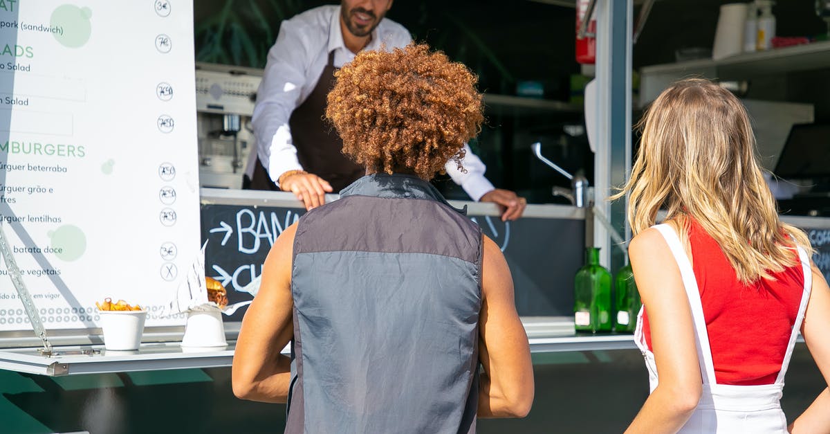 Please help me in pokemon go [duplicate] - Smiling ethnic seller consulting diverse clients on menu