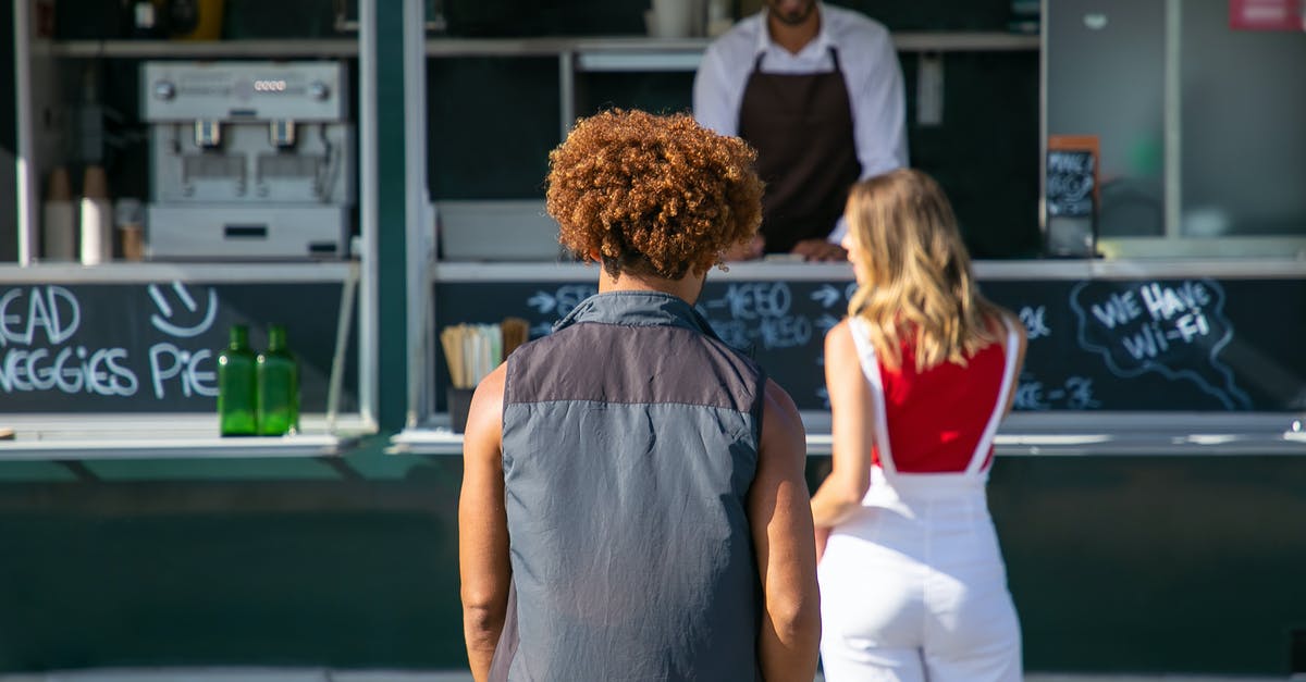 Pokémon Go: Thrown back to gym menu as soon as countdown ends - Back view of diverse clients standing near street food truck and choosing lunch