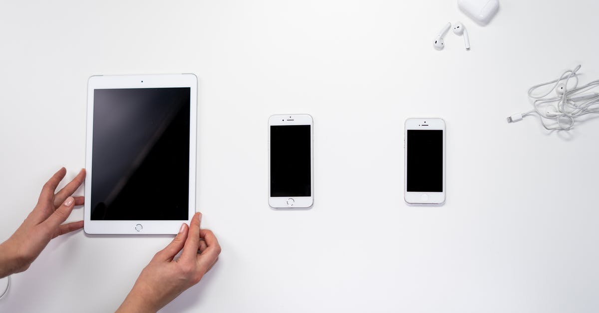 Pokemon Go - One apple ID, two Iphones - Person Holding White Ipad Beside White Ipad Pokemon Go - One apple ID, two Iphones - Person Holding White Ipad Beside White Ipad