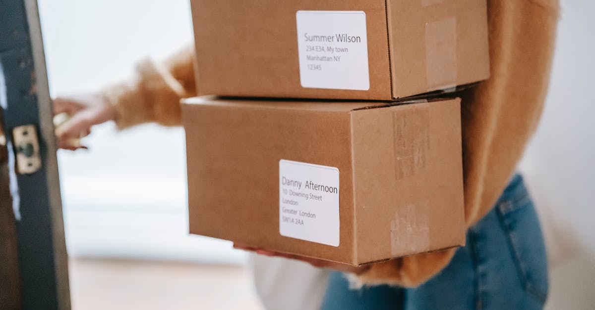 Pokemon GO- candy received for transfer - Crop unrecognizable woman carrying boxes and entering post office Pokemon GO- candy received for transfer - Crop unrecognizable woman carrying boxes and entering post office