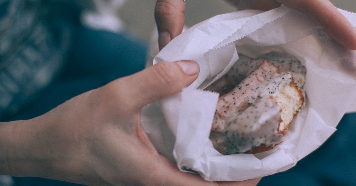 Pokemon Go Soft Ban? [duplicate] - From above of crop unrecognizable person showing tasty sweet donut with glaze in organic bag on street