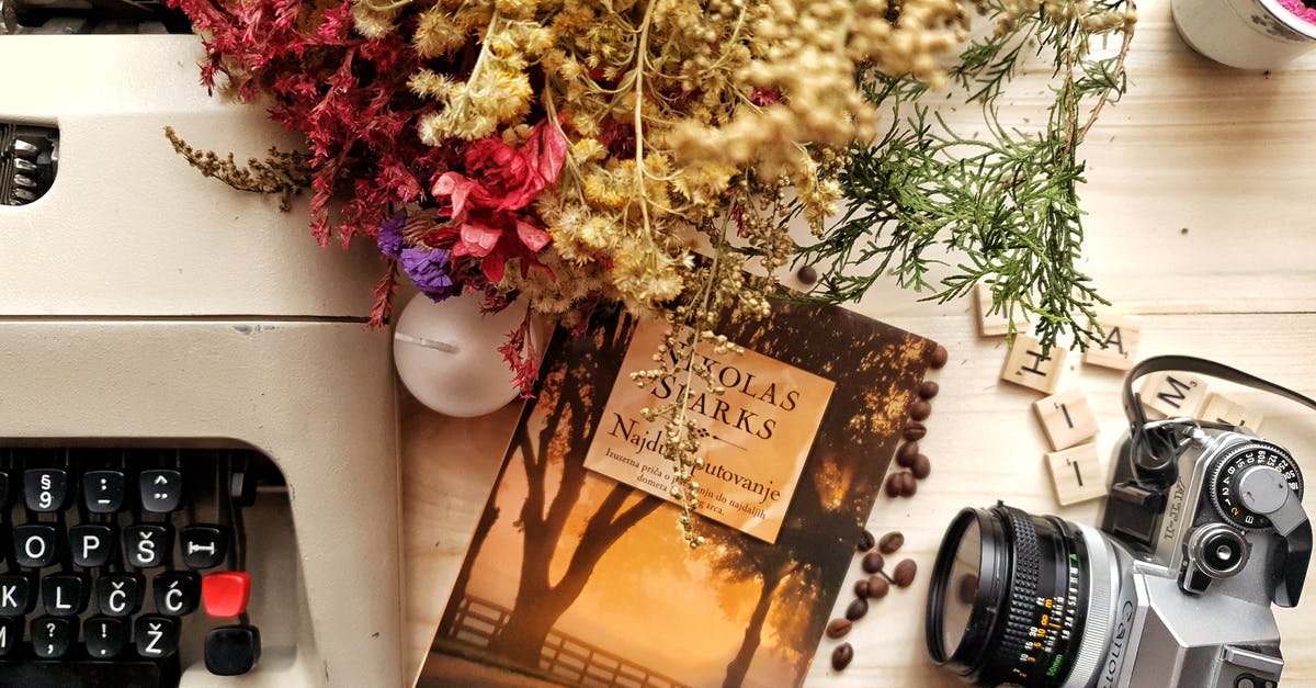 Pokemon: How do I switch back & forth from "real world" camera view? [duplicate] - Bunch of flowers and book arranged on wooden table with vintage typewriter and camera