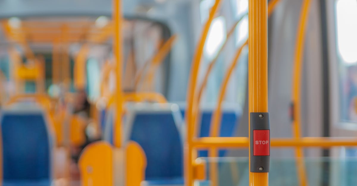Pokemon keep running away- is there any way to stop them? [duplicate] - Red stop button on yellow handrail in modern empty public bus during daytime