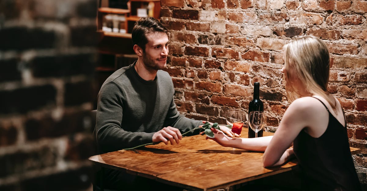 Pokemon Mystery Dungeon: Gates to Infinity - How much content does the DLC give you? - Loving boyfriend giving red rose to girlfriend while sitting near brick wall at wooden table during celebration of event in restaurant