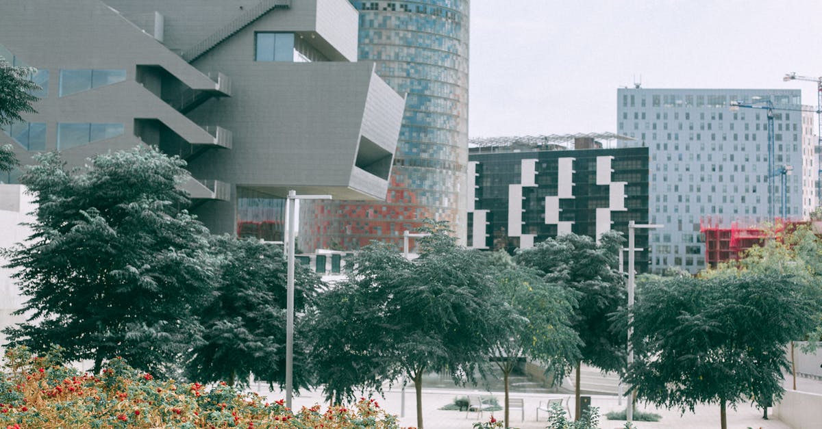 Pokemon with unusually high attack? - Lush plants and green trees against complex of big modern geometric buildings futuristic architecture style Pokemon with unusually high attack? - Lush plants and green trees against complex of big modern geometric buildings futuristic architecture style