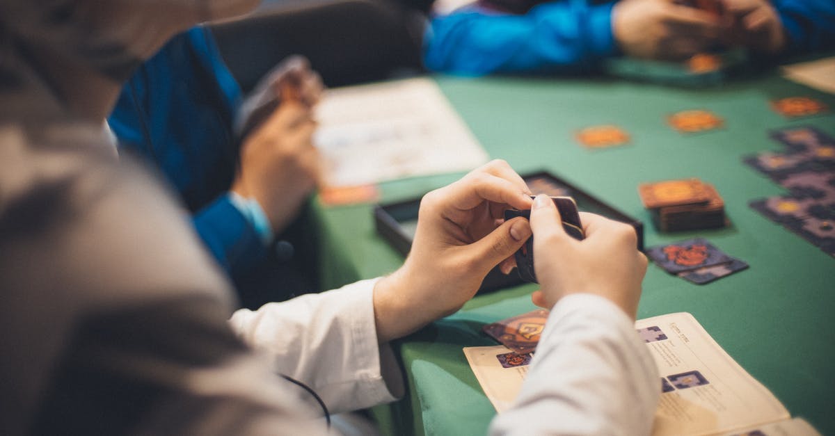 Policy card effectiveness timing - Crop people playing cards at table