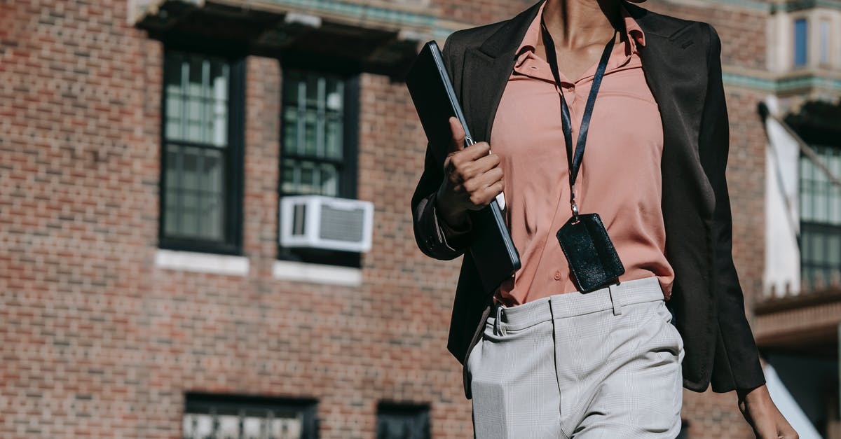 Possible to merge PC and Pocket Edition Minecraft servers? [duplicate] - Crop anonymous serious African American female entrepreneur in classy outfit with badge walking with laptop and smartphone in pocket