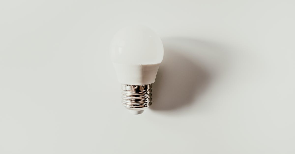 Powering a Redstone Lamp on top of a Piston - Light bulb on white surface with shadow