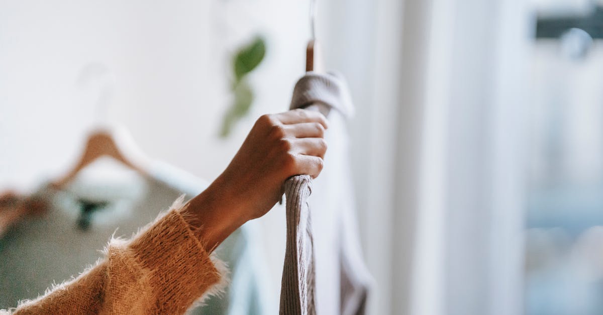 Prepare and backup Wii U for sale - Crop woman choosing apparel at home