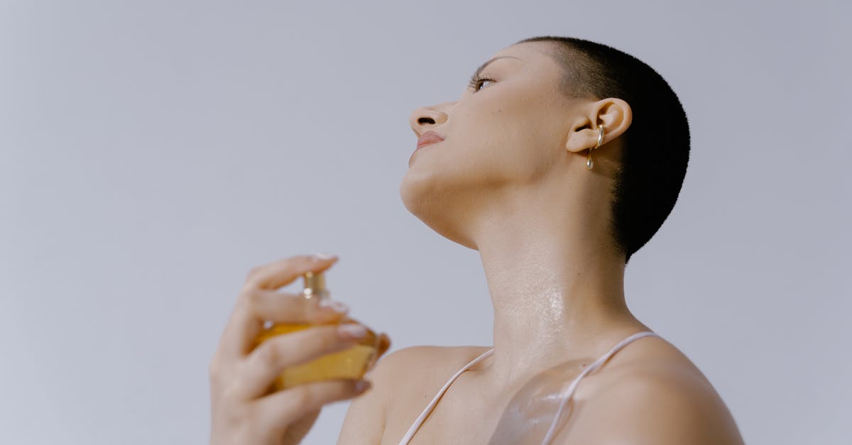 Pressing claim on an Empire - Woman Spraying Perfume on Her Neck