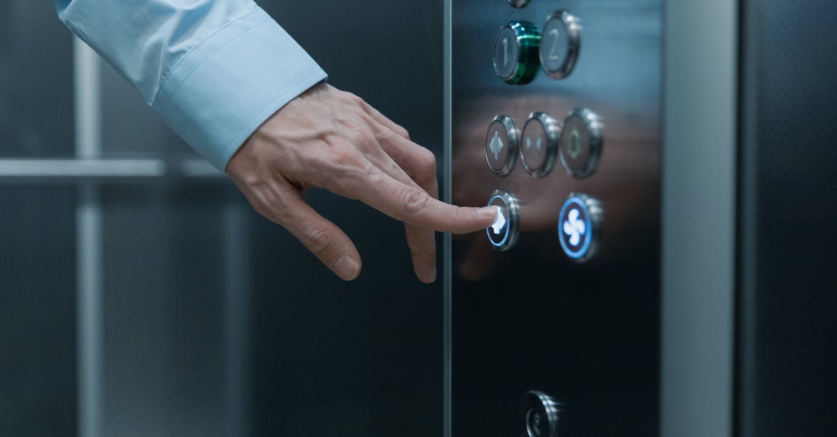 Pressing claim on an Empire - Close-Up Shot of a Hand Pressing an Elevator Button