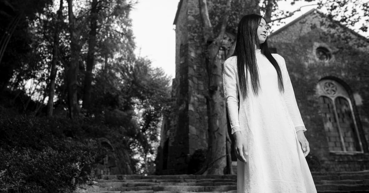 Preventing climbers into fortress - A Woman in White Long Dress Preventing climbers into fortress - A Woman in White Long Dress