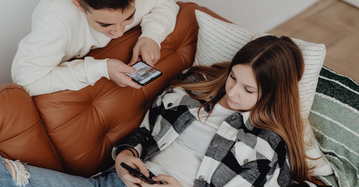Prisoners not Using Phones - A Boy and a Girl Using Smart Phones in the Living Room