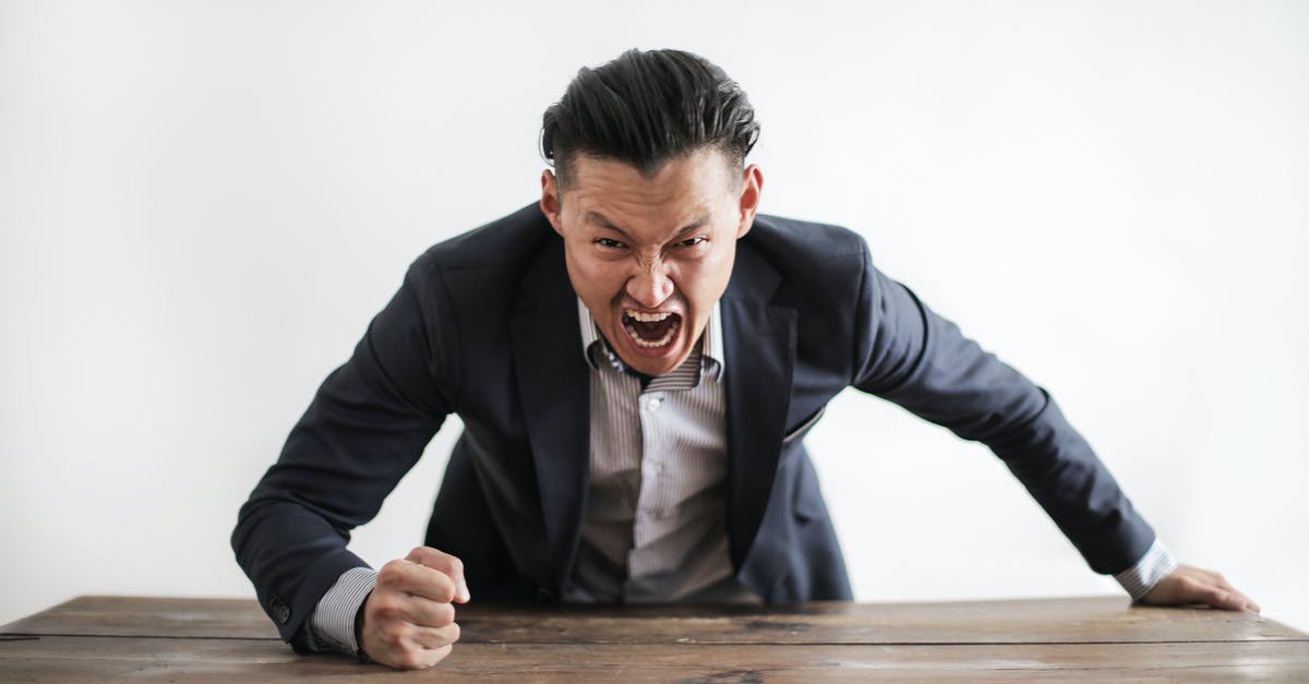 Problem with execute command - Expressive angry businessman in formal suit looking at camera and screaming with madness while hitting desk with fist
