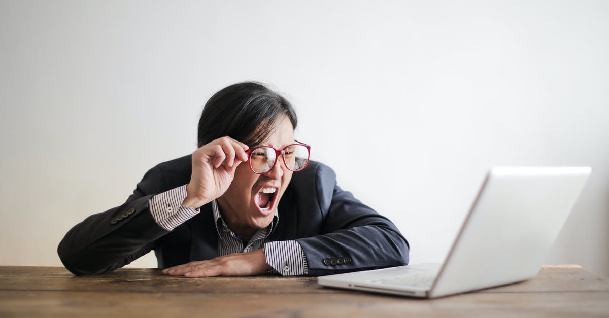 Problems with the Draug boss fight - Modern Asian man in jacket and glasses looking at laptop and screaming with mouth wide opened on white background Problems with the Draug boss fight - Modern Asian man in jacket and glasses looking at laptop and screaming with mouth wide opened on white background