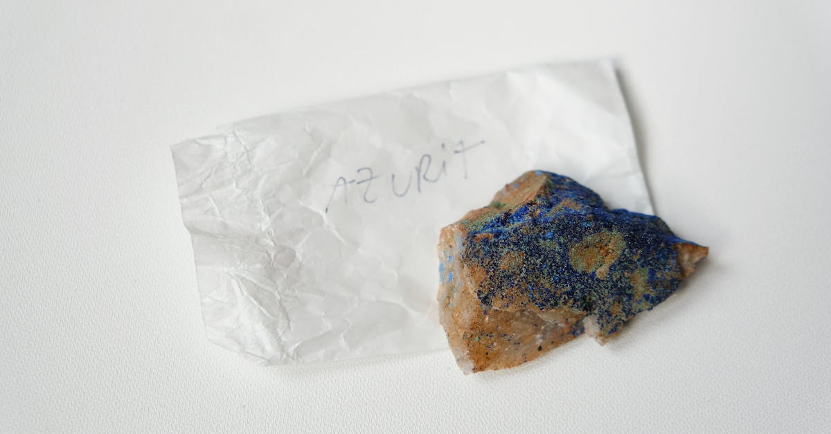 Problems with the EE3 minium stone and the Buildcraft auto-crafting table - From above of multicolored stone Azurite placed on small sheet of paper with inscription on white table Problems with the EE3 minium stone and the Buildcraft auto-crafting table - From above of multicolored stone Azurite placed on small sheet of paper with inscription on white table