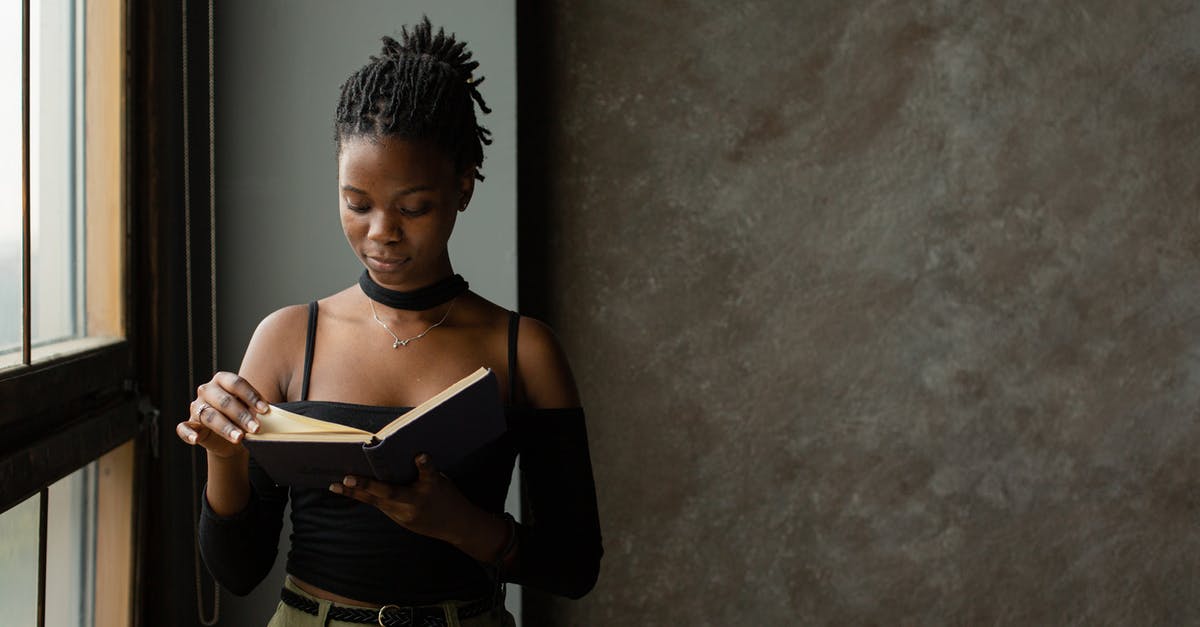 PS2 disc barely spinning read error - Focused young black woman reading book in light room