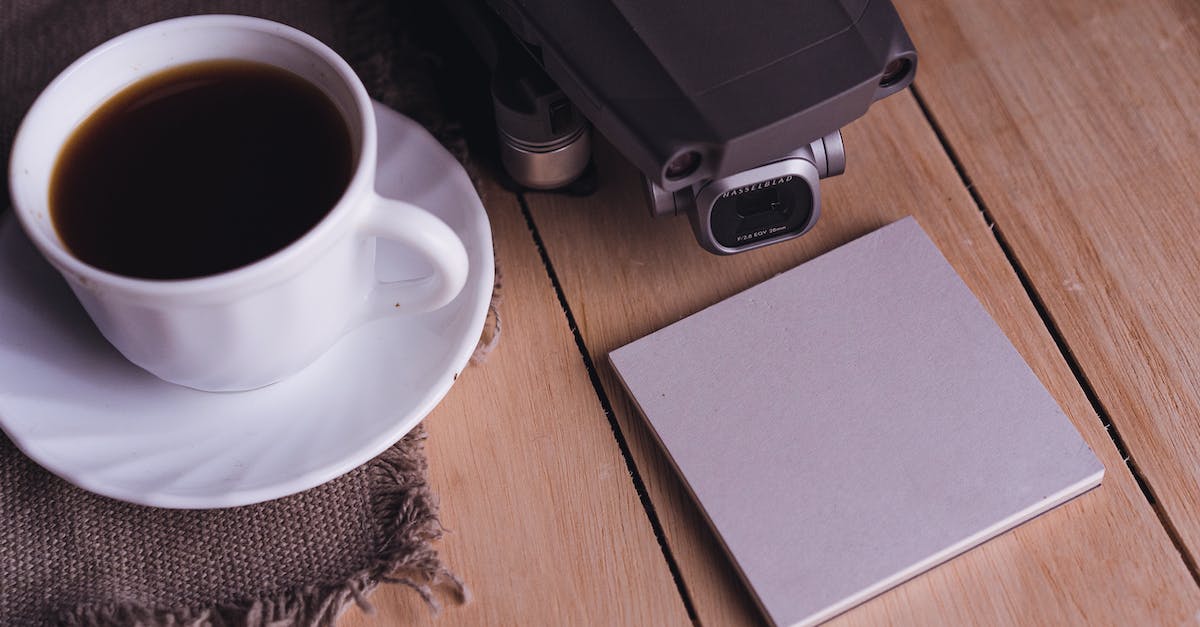 PS3 copy video files from BD-R to HDD - UAV near cup of coffee and notepad stickers on table