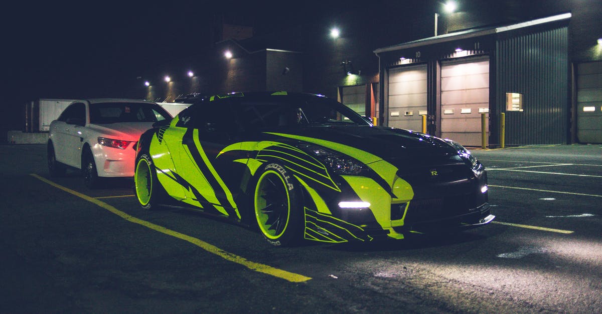 Ps4 disc drive broke - Contemporary black automobile with yellow wrapping decal design and headlights on parking lot in city street at night time outside Ps4 disc drive broke - Contemporary black automobile with yellow wrapping decal design and headlights on parking lot in city street at night time outside
