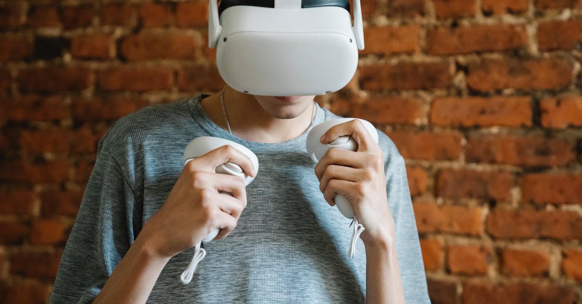 PS5 controller doesn't charge - Anonymous man experiencing virtual reality against brick wall