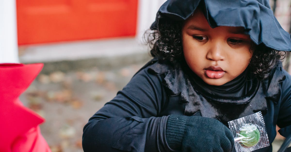 Purifier and 'appearing as witchcraft user': what happens? - Crop ethnic kid with candy in Halloween celebration