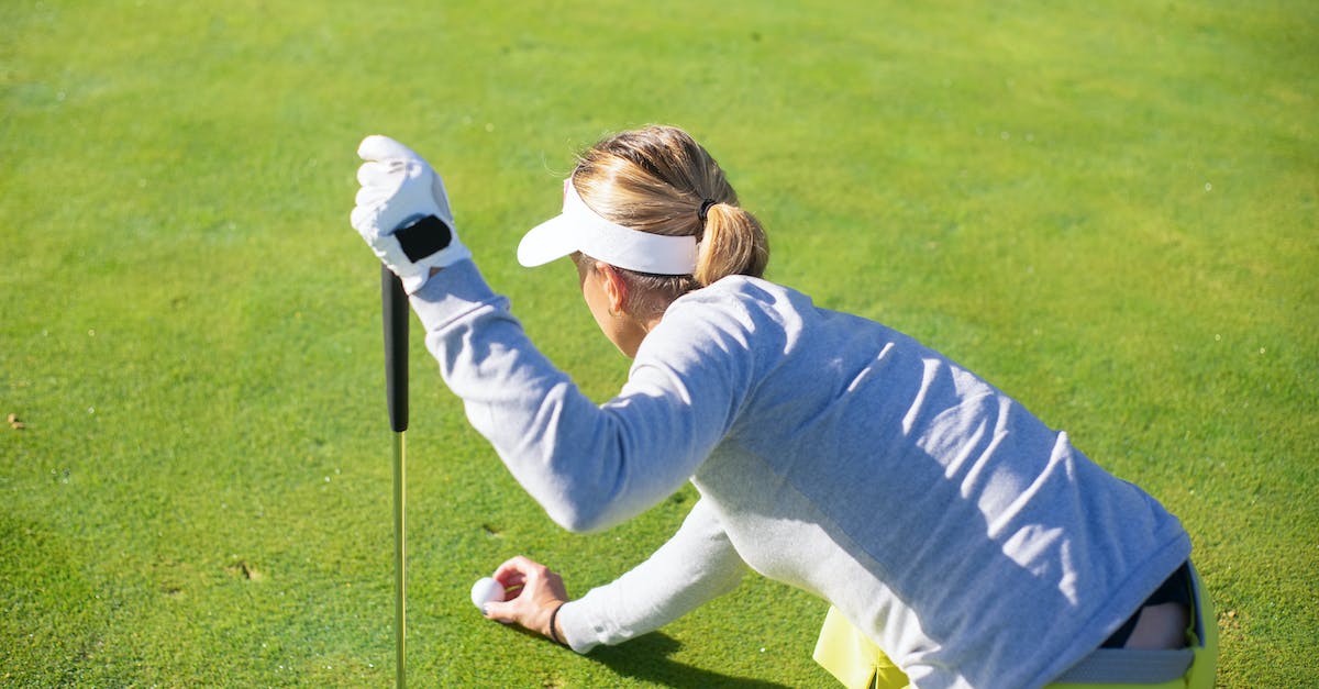Putting tags above blocks when looked at - A Woman in Gray Sweater Putting a Golf Ball on Green Grass