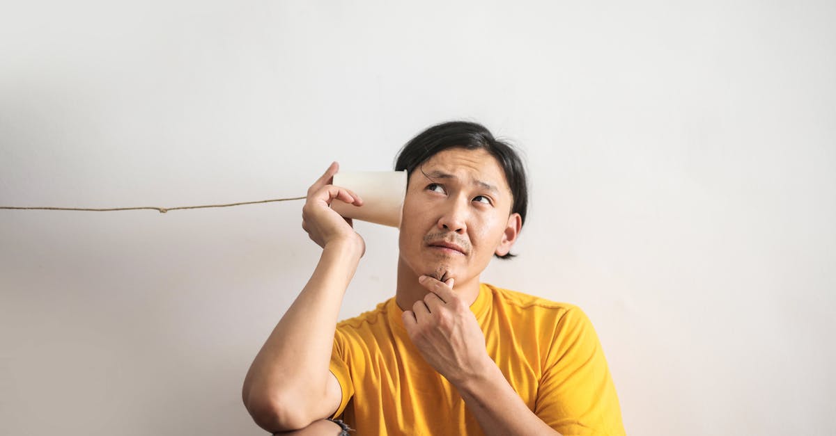 Puzzle Dragons Orb Encancing - Pensive ethnic man listening to answer in paper cup phone Puzzle Dragons Orb Encancing - Pensive ethnic man listening to answer in paper cup phone