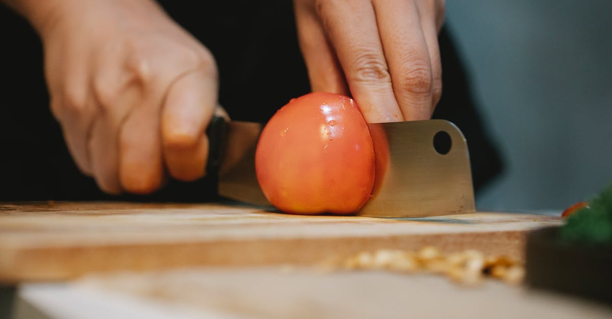 Quick Wet Goop Recipe - Cook cutting tomato on chopping board for recipe
