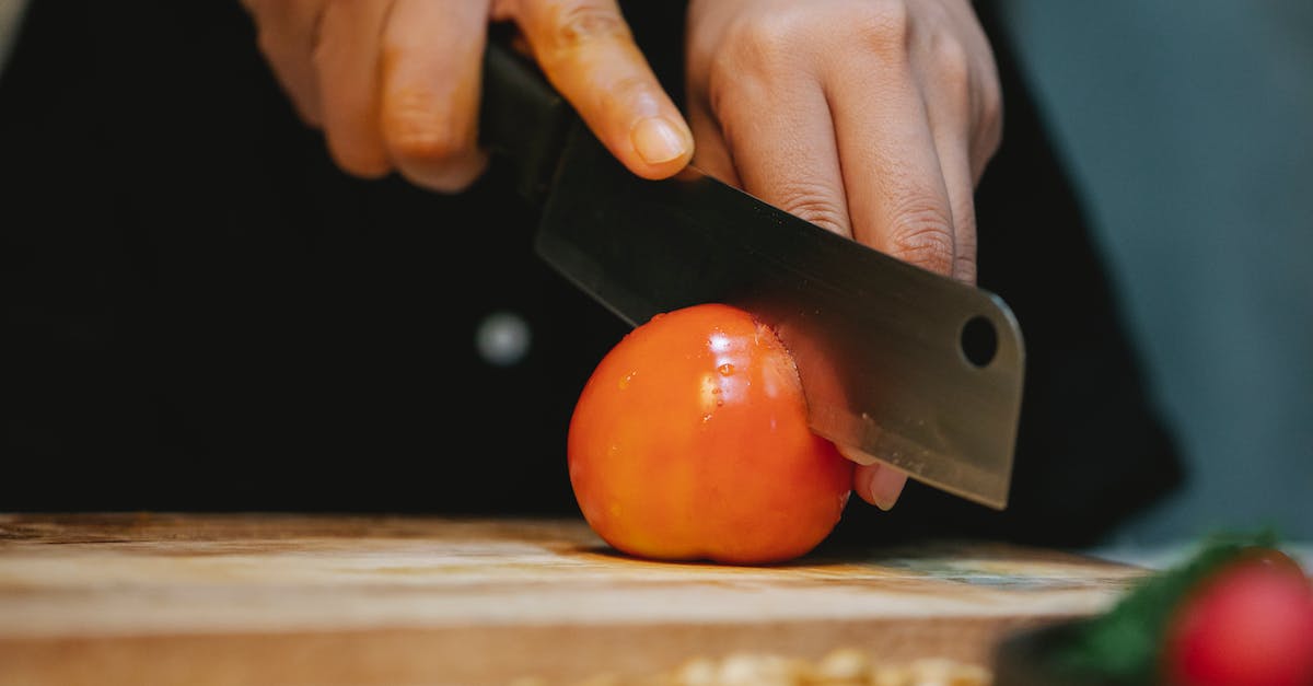 Quick Wet Goop Recipe - Chef cutting tomato with knife on wooden cutting board