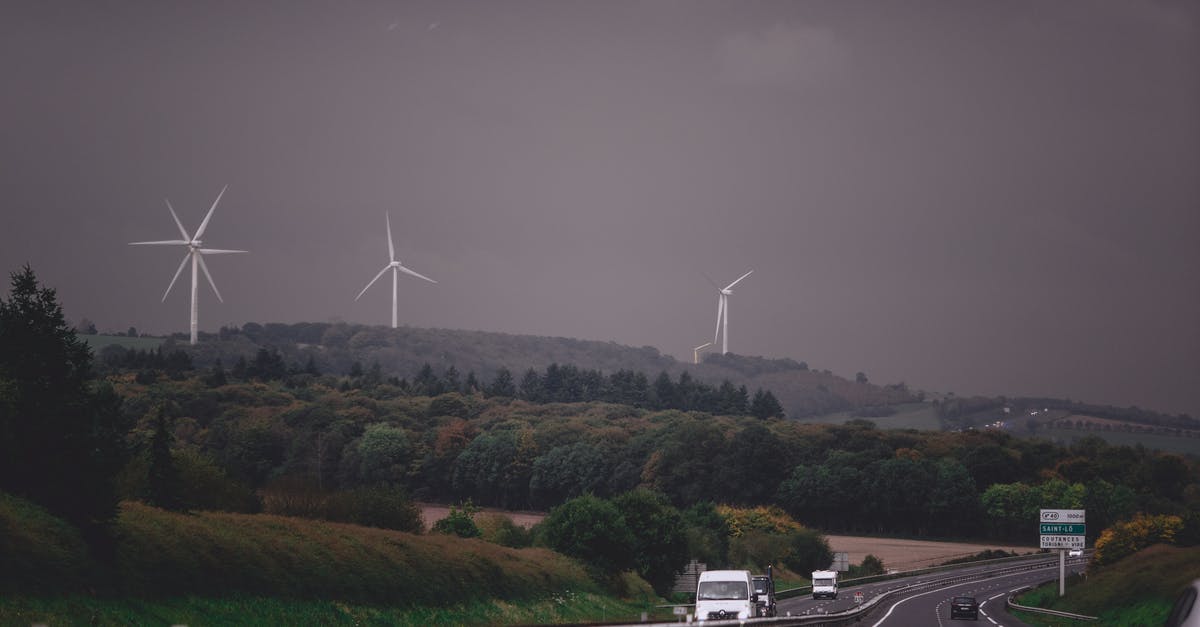 Quickest way to power rank? - Asphalt highway running through grassy lush valley with modern wind turbine generators under gloomy overcast sky Quickest way to power rank? - Asphalt highway running through grassy lush valley with modern wind turbine generators under gloomy overcast sky