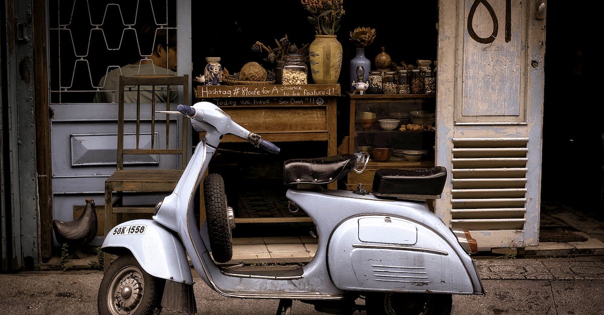 "You have nowhere to store this vehicle" - White and Black Motor Scooter Parked Near Building