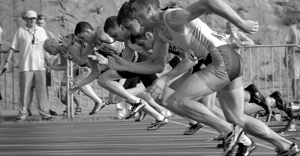 Race Start Mode of Gran Turismo 5 - Athletes Running on Track and Field Oval in Grayscale Photography