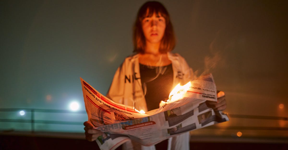 Radiance and Song of Flame - A Woman Holding s Burning Newspaper Radiance and Song of Flame - A Woman Holding s Burning Newspaper