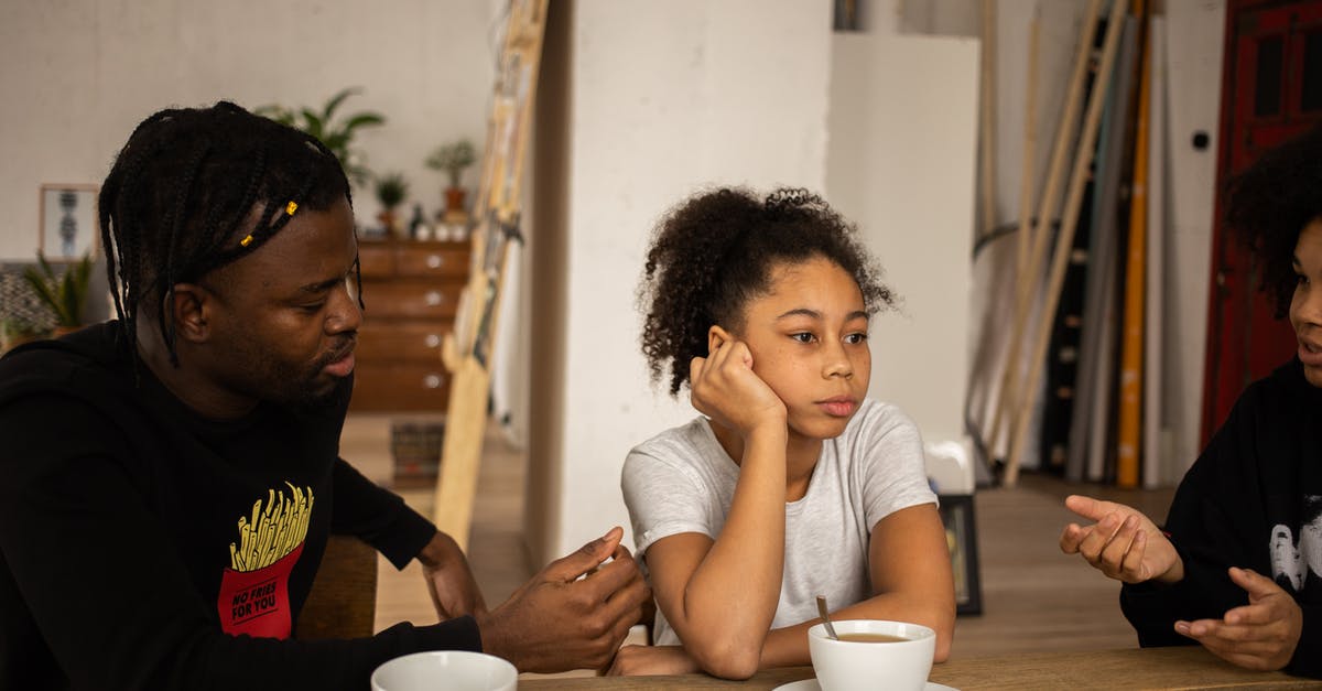 Randomness in Zero Time Dilemma - Frustrated black girl between arguing parents at table