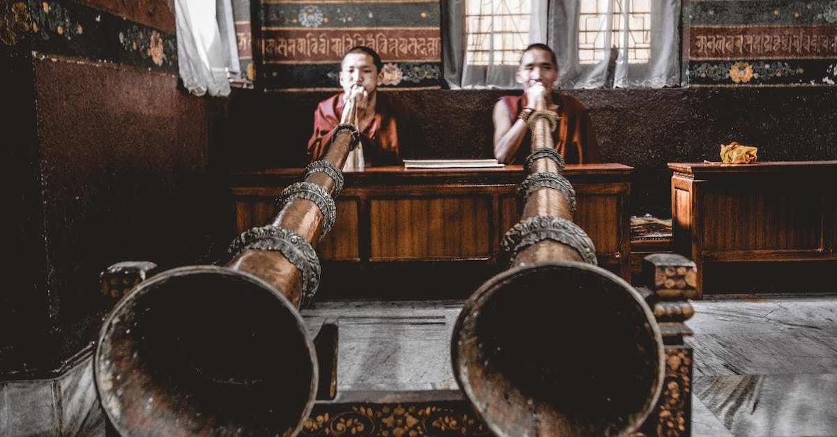 Realm of the Mad god is too laggy to play - Man Tibetan musicians playing dungchen instrument in temple Realm of the Mad god is too laggy to play - Man Tibetan musicians playing dungchen instrument in temple