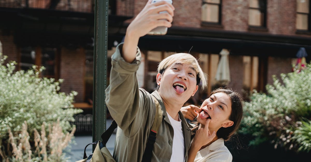 Rebuild 3: Do these buildings have any uses? - Happy young ethnic couple making funny grimace while taking selfie on smartphone Rebuild 3: Do these buildings have any uses? - Happy young ethnic couple making funny grimace while taking selfie on smartphone