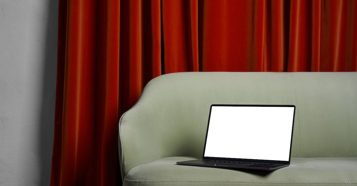 Red border/frame around screen - Laptop on couch near red curtains and wall