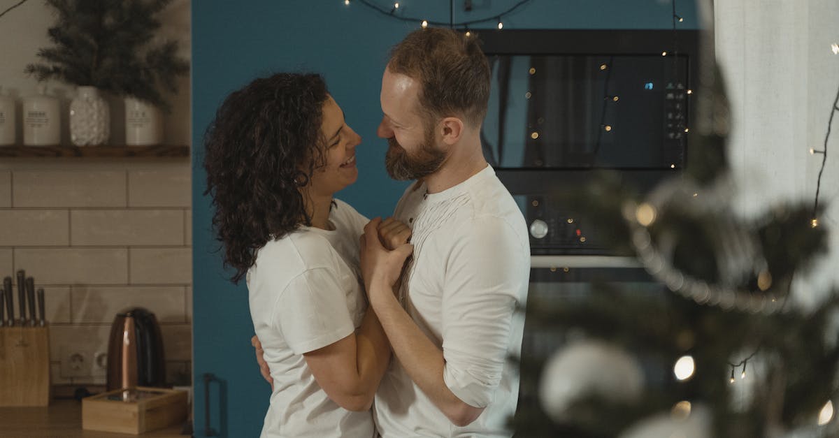Relationship between NORG and Martine - Man in White Polo Shirt Kissing Woman in White Shirt