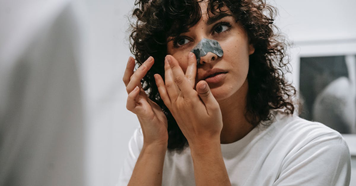 Remove donated troops during preparation phase - Curly woman applying nose strip in bathroom