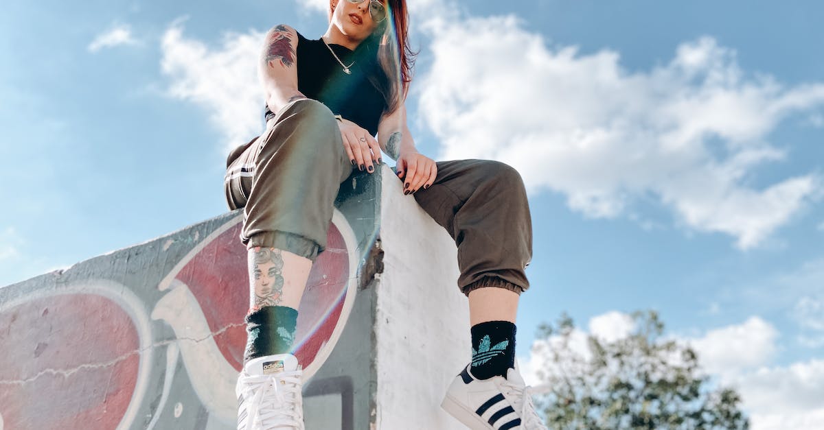 Remove ramp from z+1 layer - Rebellious tattooed lady relaxing in skate park on sunny day