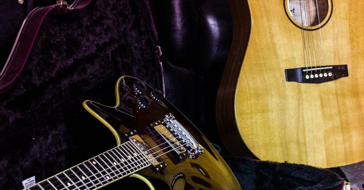 Removing neck from guitar - Professional string musical instruments of classical and contemporary black electric guitars with open bag