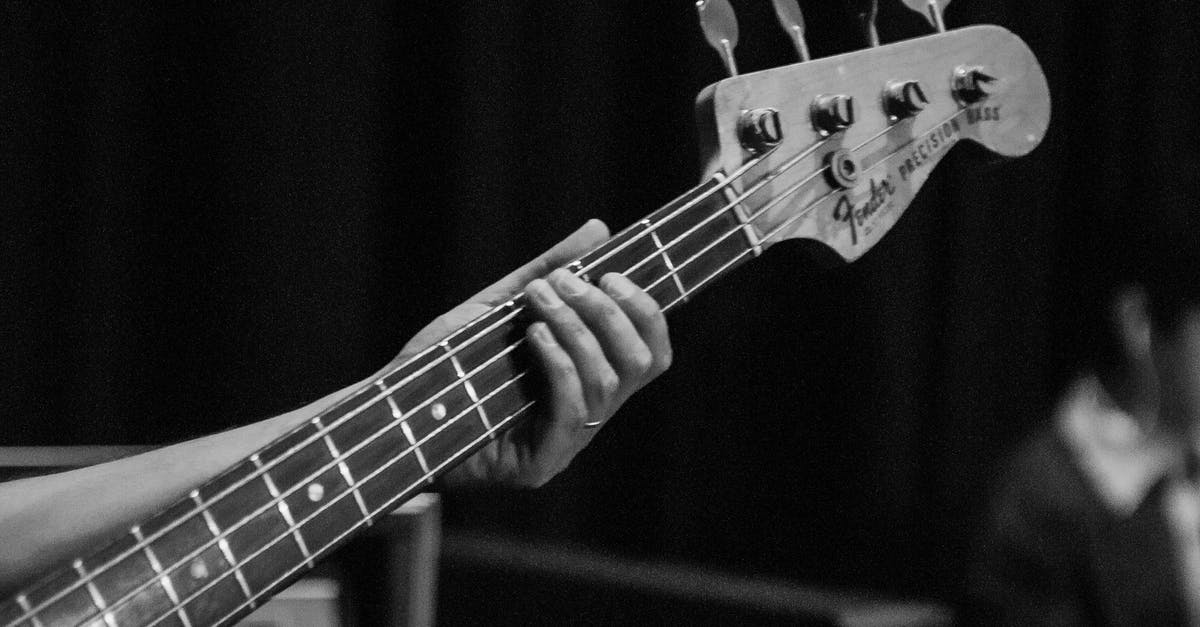 Removing neck from guitar - Crop unrecognizable guitarist holding guitar neck